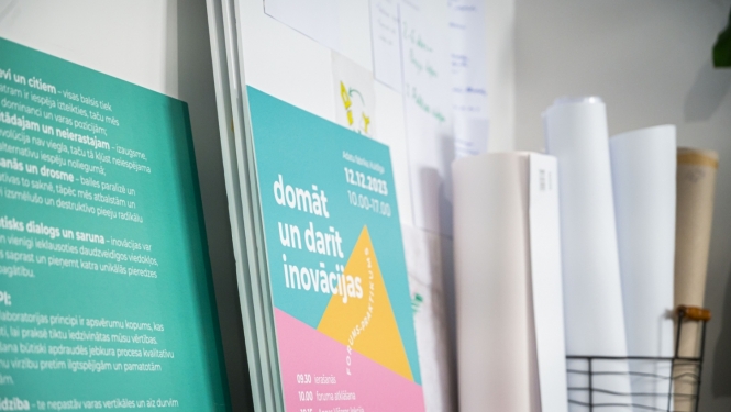 Plaukts ar plakātu par inovāciju laboratoriju