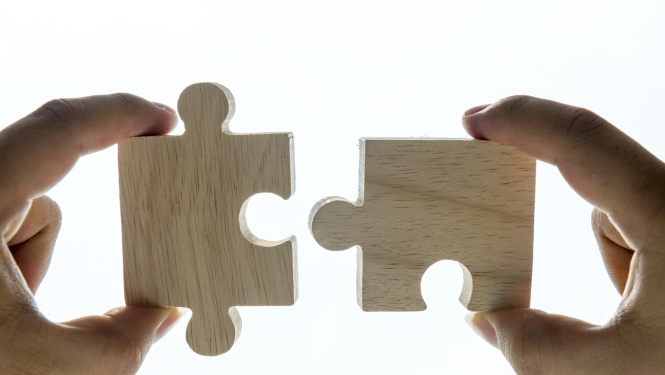 Rokas savieno puzle gabaliņus